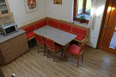 a kitchen with a table and chairs and a counter at Charming countryside house in Lome