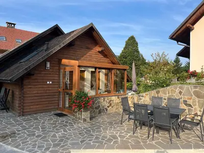 a house with a stone patio with a table and chairs at Charming countryside house in Lome
