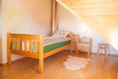 a bedroom with a wooden bunk bed with a staircase at Cottage House Jakob in Cerklje na Gorenjskem