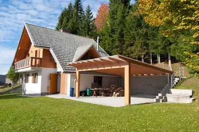 a house with a pavilion with a table in it at Cottage House Jakob in Cerklje na Gorenjskem