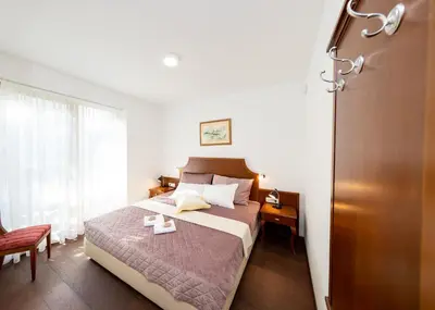 a hotel room with a bed and a window at Villa Mihaela in Bled