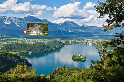 a house on an island in the middle of a lake at Apartments Fine Stay Slovenia in Žirovnica