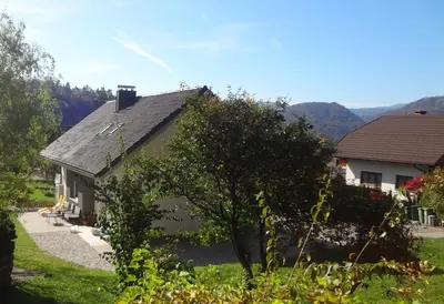 a house with a roof and a yard at Apartments Fine Stay Slovenia in Žirovnica