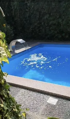 a swimming pool with a water fountain in it at Apartman MURKO P-2 in Brest