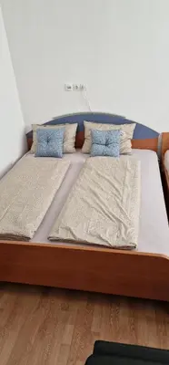 a large bed with two pillows on top of it at Apartman MURKO P-2 in Brest