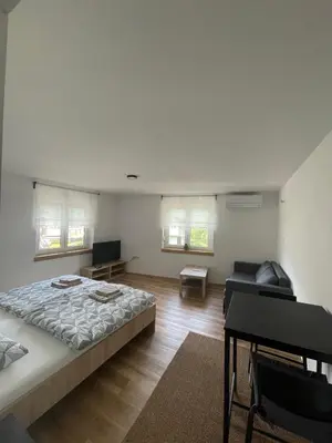 a bedroom with a large bed and a couch at Azimut Hiša in Tolmin