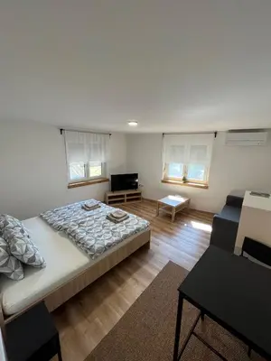 a bedroom with a large bed and a couch at Azimut Hiša in Tolmin