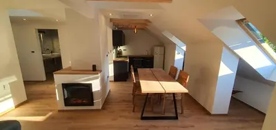 a kitchen and dining room with a table and a fireplace at Weekend House Solis - Bovec in Bovec
