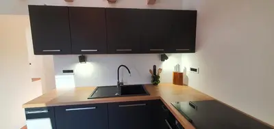 a kitchen with black cabinets and a sink at Weekend House Solis - Bovec in Bovec