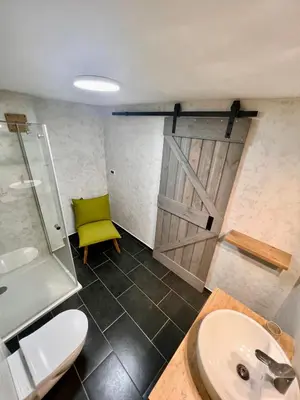 a bathroom with a sink and a sliding door at Weekend House Solis - Bovec in Bovec