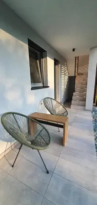 two chairs and a wooden table in a house at Weekend House Solis - Bovec in Bovec