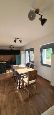 a dining room with a wooden table and chairs at Weekend House Solis - Bovec in Bovec