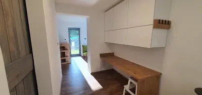a room with a hallway with a table and cabinets at Weekend House Solis - Bovec in Bovec