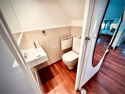 a bathroom with a toilet and a sink at Galleria apartment Ljubljana in Ljubljana
