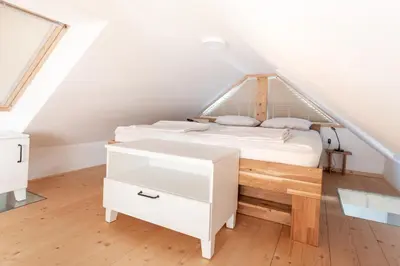 a bedroom with a white bed in a attic at Lavender Lodge Bled in Bled
