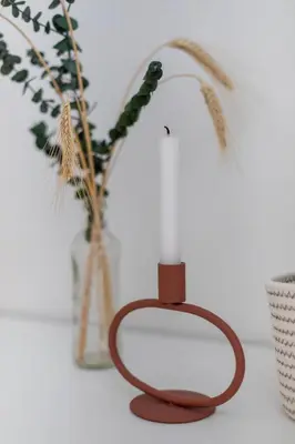 a candle on a table next to some plants at Lavender Lodge Bled in Bled