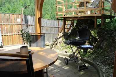 a chair sitting on a patio next to a table at Lavender Lodge Bled in Bled