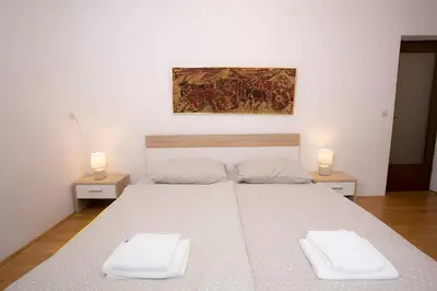 a bedroom with a bed with two white towels at Apartment Vera Kranjska Gora in Kranjska Gora