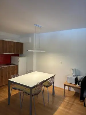 a table and chairs in a room with a kitchen at Apartment Vera Kranjska Gora in Kranjska Gora