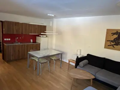 a living room with a couch and a table at Apartment Vera Kranjska Gora in Kranjska Gora