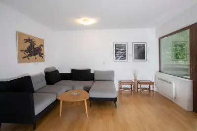 a living room with a couch and a table at Apartment Vera Kranjska Gora in Kranjska Gora