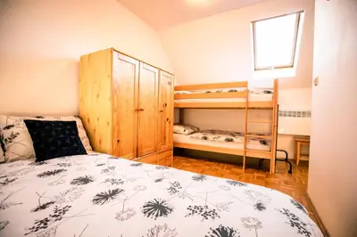 a bedroom with a bed and two bunk beds at POČITNIŠKI APARTMAJI - Trobentica 37 Apartment Golf Moravske Toplice in Moravske Toplice