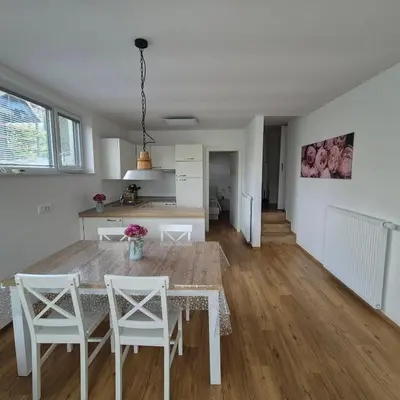 a kitchen and dining room with a table and chairs at Annie's apartment in Bled