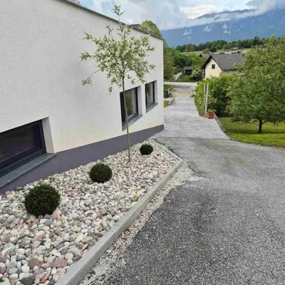 a house with a tree on the side of it at Annie's apartment in Bled