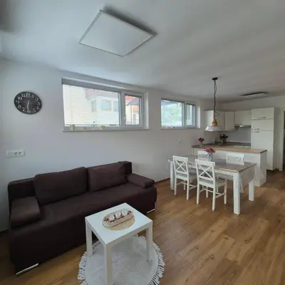 a living room with a couch and a table at Annie's apartment in Bled