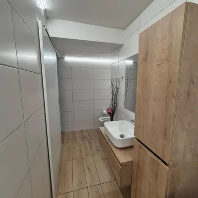a small bathroom with a sink and a toilet at Annie's apartment in Bled