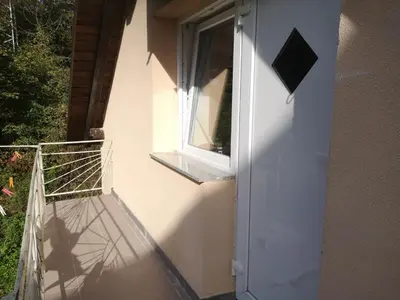 a balcony with a window on the side of a building at Small house in Celje in Celje