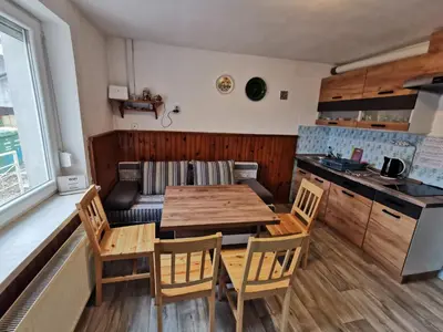 a kitchen and dining room with a table and chairs at Small house in Celje in Celje