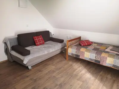 a living room with a couch and a bed at Small house in Celje in Celje
