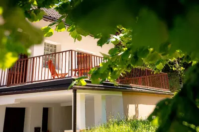 a building with a balcony with a chair on it at Elegant House in a Beautiful Village in Cerklje ob Krki