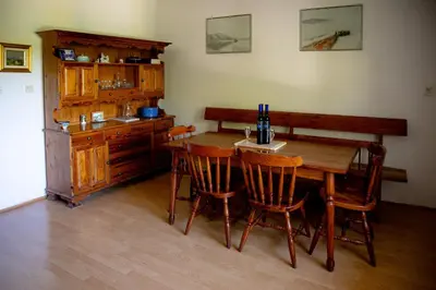 a dining room with a wooden table and chairs at Elegant House in a Beautiful Village in Cerklje ob Krki