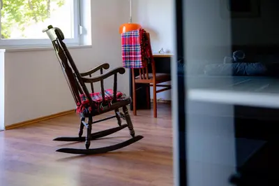 a rocking chair sitting in a room with a window at Elegant House in a Beautiful Village in Cerklje ob Krki