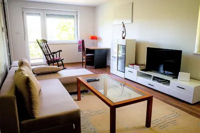 a living room with a couch and a tv at Elegant House in a Beautiful Village in Cerklje ob Krki
