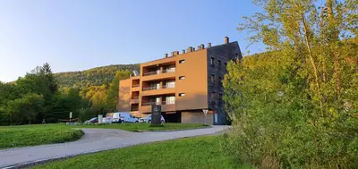 a building on the side of a hill with a road at Mari 14 in Maribor