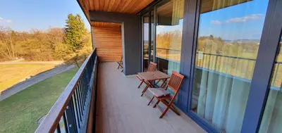a balcony with two chairs and a table on it at Mari 14 in Maribor