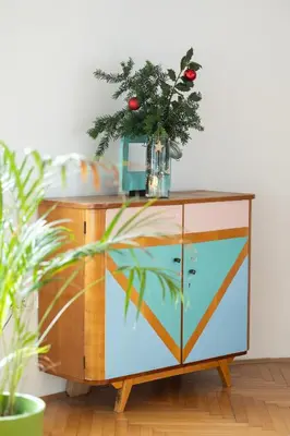 a dresser with a christmas tree on top of it at Nice family friendly apartment in the city center in Ljubljana