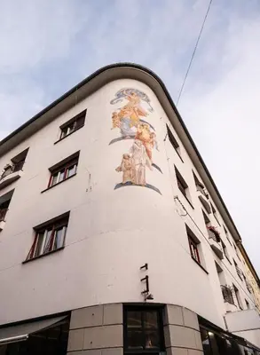 a building with a painting on the side of it at Nice family friendly apartment in the city center in Ljubljana