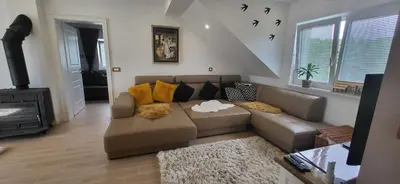 a living room with a couch and a fireplace at Villa Hojnik in Videm pri Ptuju