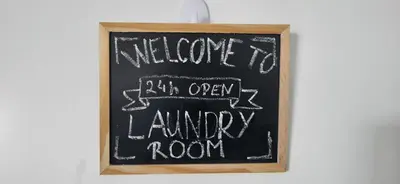a chalkboard sign with welcome to an open laundry room at Villa Hojnik in Videm pri Ptuju
