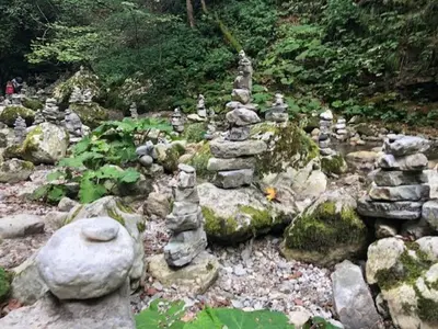 a group of rocks on a rocky ground with trees at Family Home Kobarid - Soca and Nadiza apartament in Kobarid