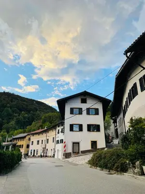 a row of white buildings in a village at Family Home Kobarid - Soca and Nadiza apartament in Kobarid