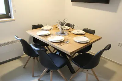 a dining room table with black chairs and a wooden table at Apartment Bajta - Rogla in Zreče