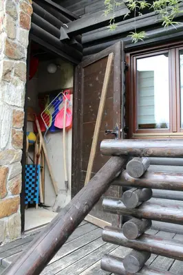 a group of logs sitting on a deck next to a door at Apartment Bajta - Rogla in Zreče