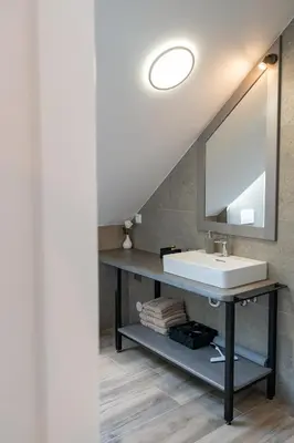 a bathroom with a sink and a mirror at Prima Countryside Apartments in Žirovnica
