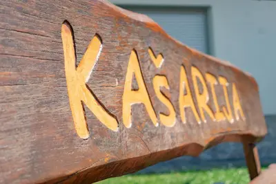 a wooden bench with the word x academy written on it at Prima Countryside Apartments in Žirovnica