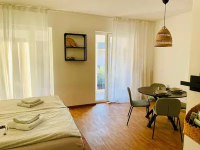 a bedroom with a bed and a table and chairs at HAY Apartment Bled in Bled